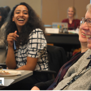People sat on chairs laughing 
