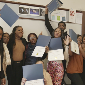 students displaying certificates