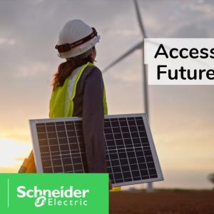 A person carrying a solar panel outside. A wind turbine in the distance. Schneider Electric logo. 