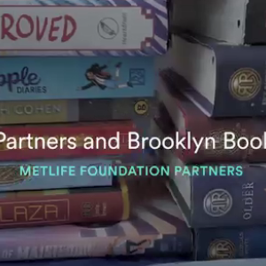 Close up of stacks of books. "Reading Partners and Brooklyn Book Bodega"