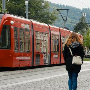 Two people walking next to a train