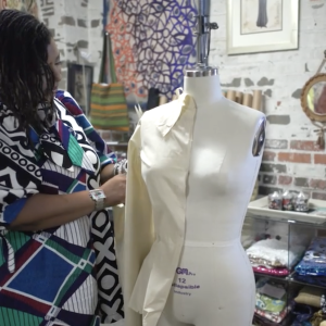 Dru Christine working with a design on a bust form.