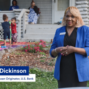 Marla Dickinson standing outside Elijah's home, two kids playing in the background.