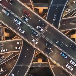 Aerial view of cars driving on multi-lane and multi-level highways.