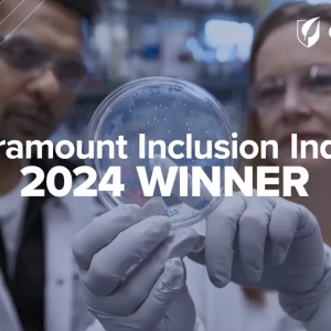 Two people looking at a petri dish that one is holding up. "Seramount Inclusion Index 2024 Winner".