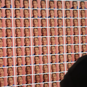 A large screen displaying multiple AI avatar faces