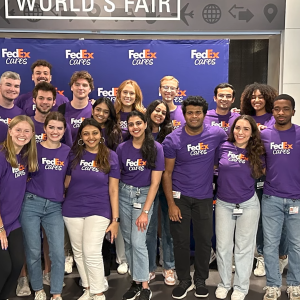 A large group photo of interns wearing purple FedEx Cares t-shirts 