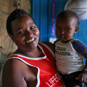 Woman holding child and smiling 