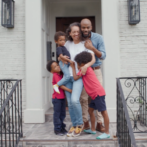 Kenzel Fallen and family on a front porch.