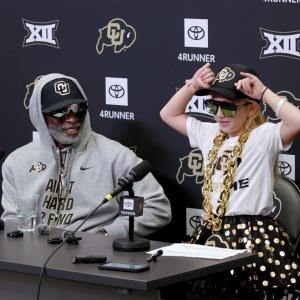 Coach Prime and Piper. 