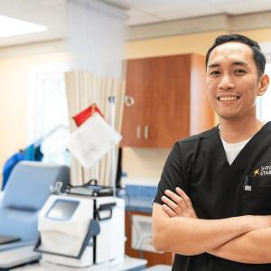 A person in scrubs in a health care setting