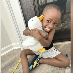 Young boy shown holding his Aflac Duck.