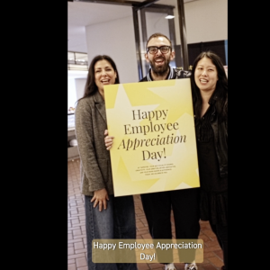 Tapestry employees holding employee appreciation day sign