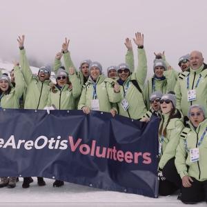 Group of Otis volunteers holding We Are Otis banner.