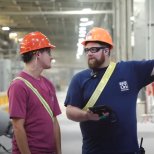 Two workers in orange hard hats