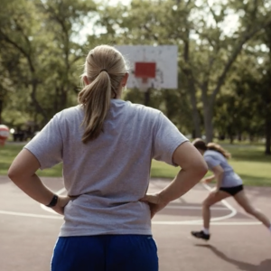 RaNae Isaak watching kids play basketball