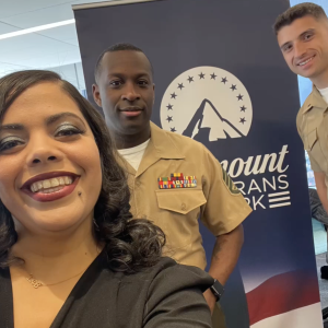 Service members standing in front of Paramount banner