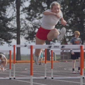athlete jumping a hurdle