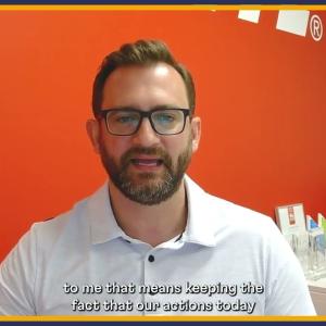 Someone shown talking in front of a red background