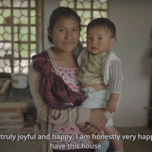 A mother holding her child in their new family home.