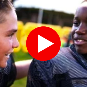 Two youth football players shown in their uniforms.