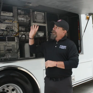 A person talking next to a vehicle