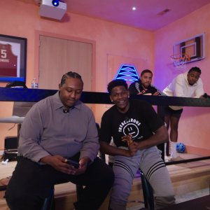 Two people sitting together with others looking on from above