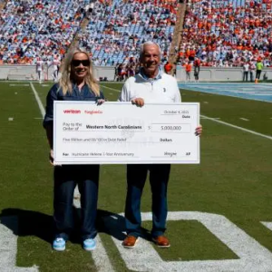 Two people holding an oversized check
