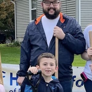 Family with two kids all holding shovels