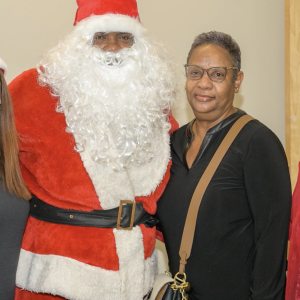 Customer meeting Entergy officials and person dressed up as Santa