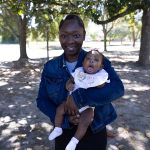 A young mother holding her baby