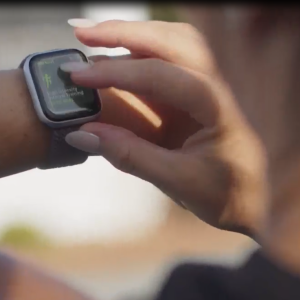 Woman scrolls through her Apple Watch exercise settings. 
