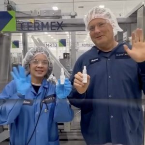 two people smiling and waving