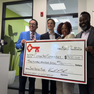 Team members from The KeyBank Foundation present a check for $300,000.