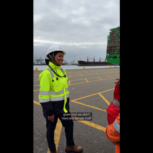 Cynthia Garrido, wearing a hard hat and high-visibility PPE, speaks with colleagues at DP World's container terminal in Callao, Peru