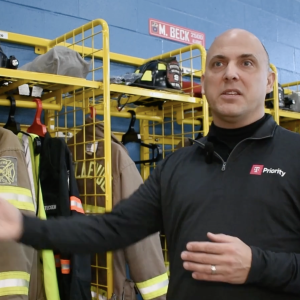 First responder in front of firefighting equipment
