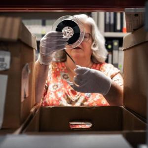 Lori winding up negatives on a roller