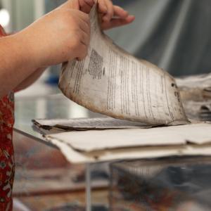 Lori handling very old, discolored papers