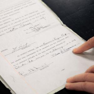 Lori displaying signatures on old paperwork