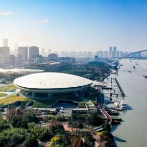Aerial view of the Mercedes-Benz Arena Shanghai beside the Huangpu River.