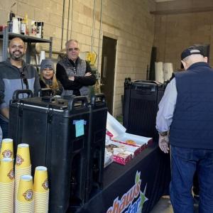 People serving coffee and donuts at Wreaths Across America event