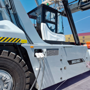 Close-up of electric charging cables connected to SANY SRSC45E3 Reach Stacker at DP World Lirquén terminal.