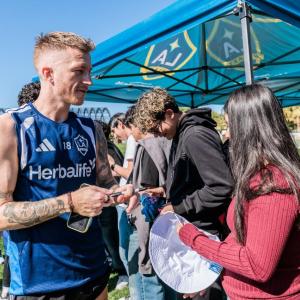 Students participate in an autograph session with LA Galaxy players following a behind‑the‑scenes look at professional training at the Empire Polo Grounds.