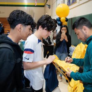 LA Galaxy's Jose “Memo” Rodriguez passes out LA Galaxy backpacks to students in Coachella Valley.