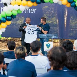 LA Galaxy's President Chris Klein presents Long Beach Mayor Rex Richardson with a customized jersey at the ceremony.