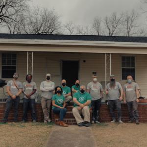 volunteers in front of home