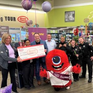 Group of people holding a check in a Jewel-Osco store
