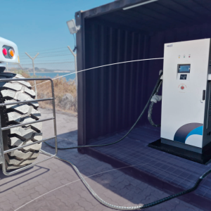 Electric vehicle charging unit connected to heavy port equipment at DP World Lirquén terminal in Chile.