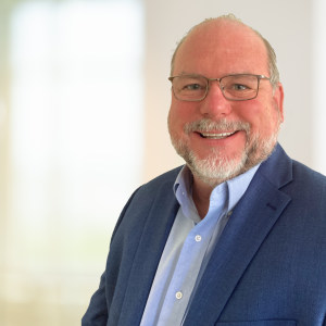 Sam Kitchell smiling at the camera.