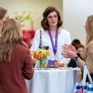 Four people talking around a table